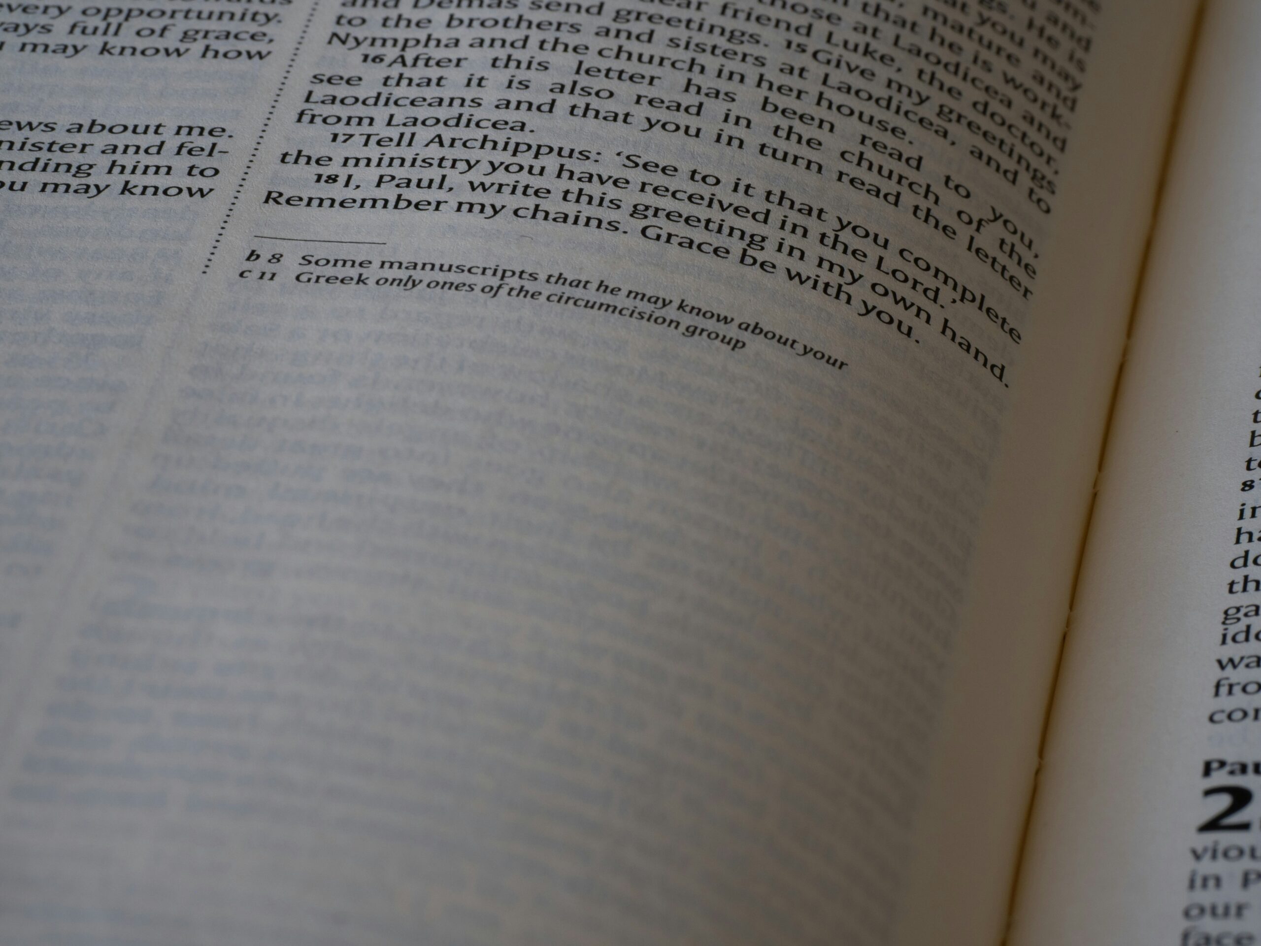 A hand pointing at fine print on a policy document highlighting exclusions.