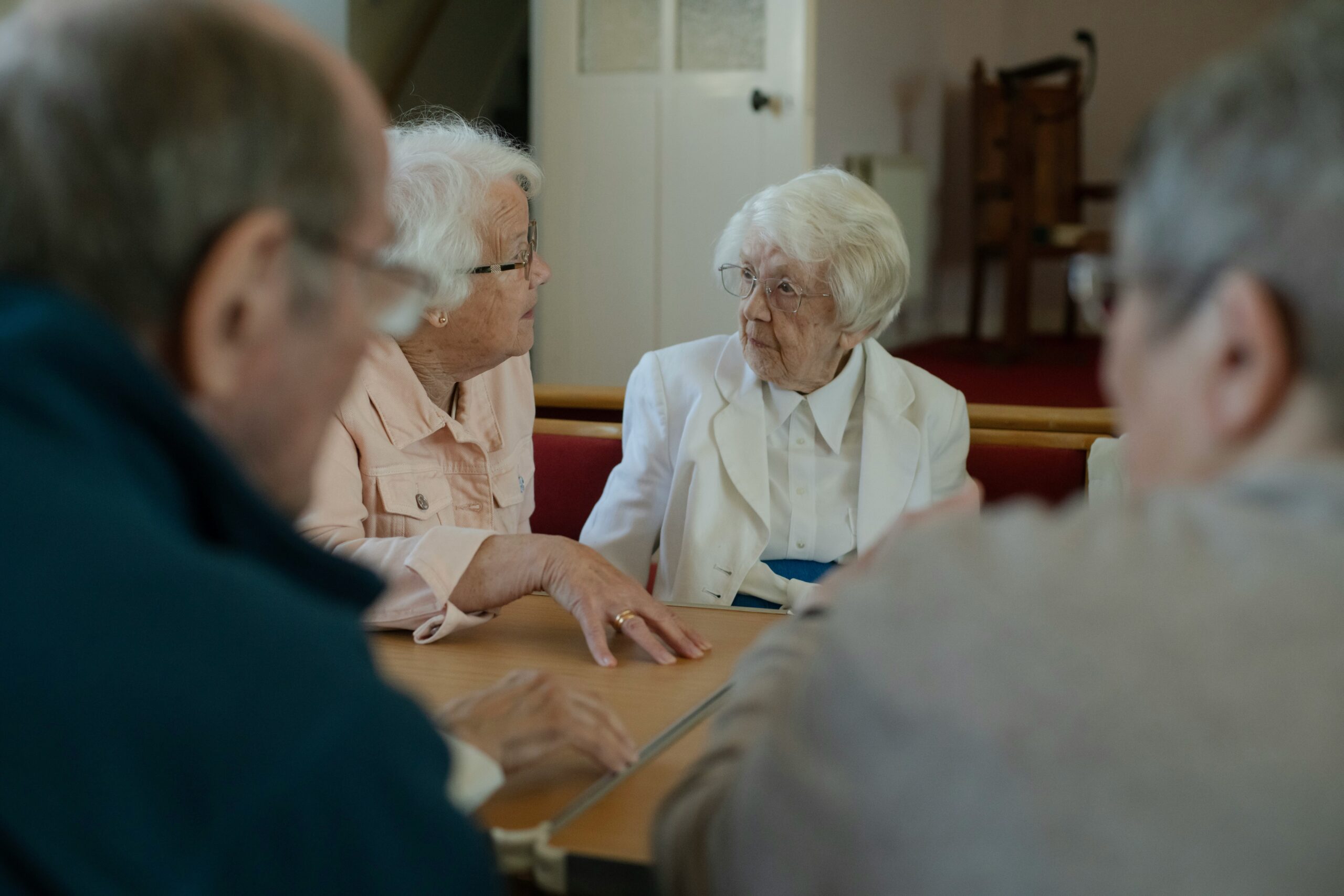 Photo of smiling woman holding framed picture of her elderly mother