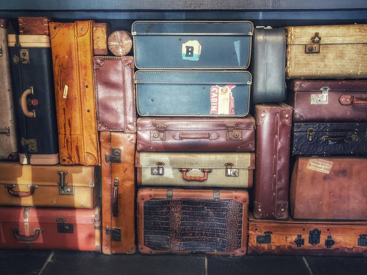 Retro style suitcases neatly stacked. Times gone by before suitcases were lightweight. However these cases have lasted over time. I love the old fashioned look of them, it takes me back to a time now past. It makes me smile to think of when traveling the clasp would sometimes spring open, even when locked. I think these cases still have more style.