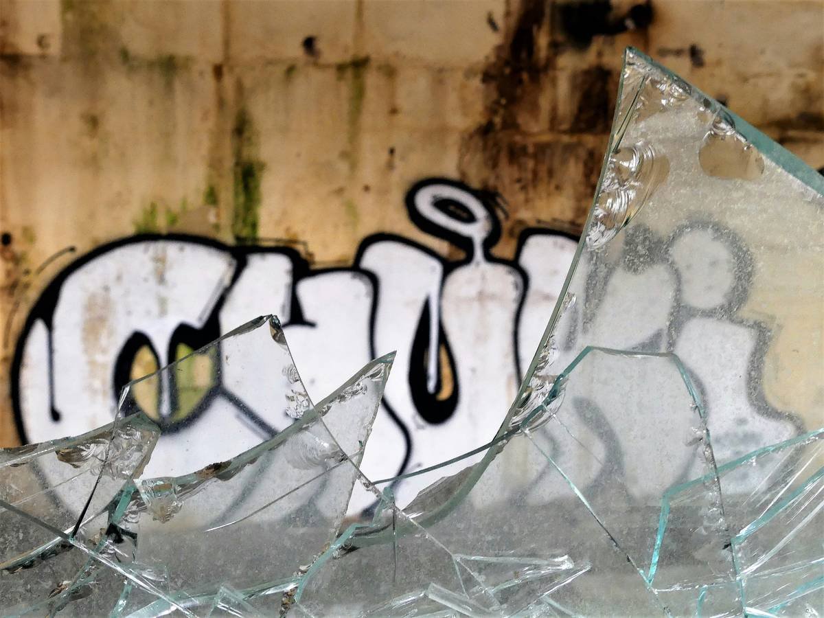 white and black graffiti on brown wall